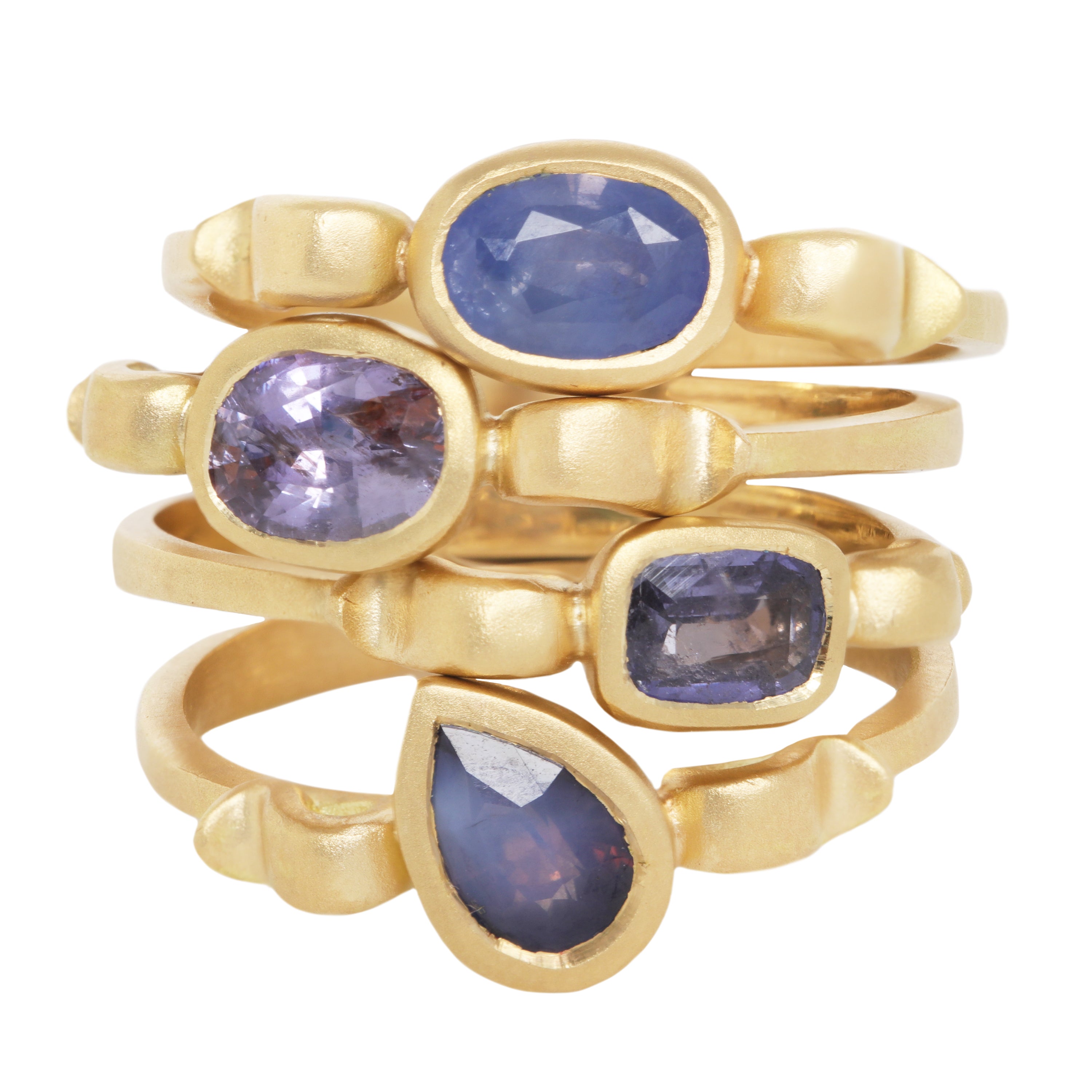 Stack of 4 yellow gold rings each with shapes inspired  by the greek hydria.