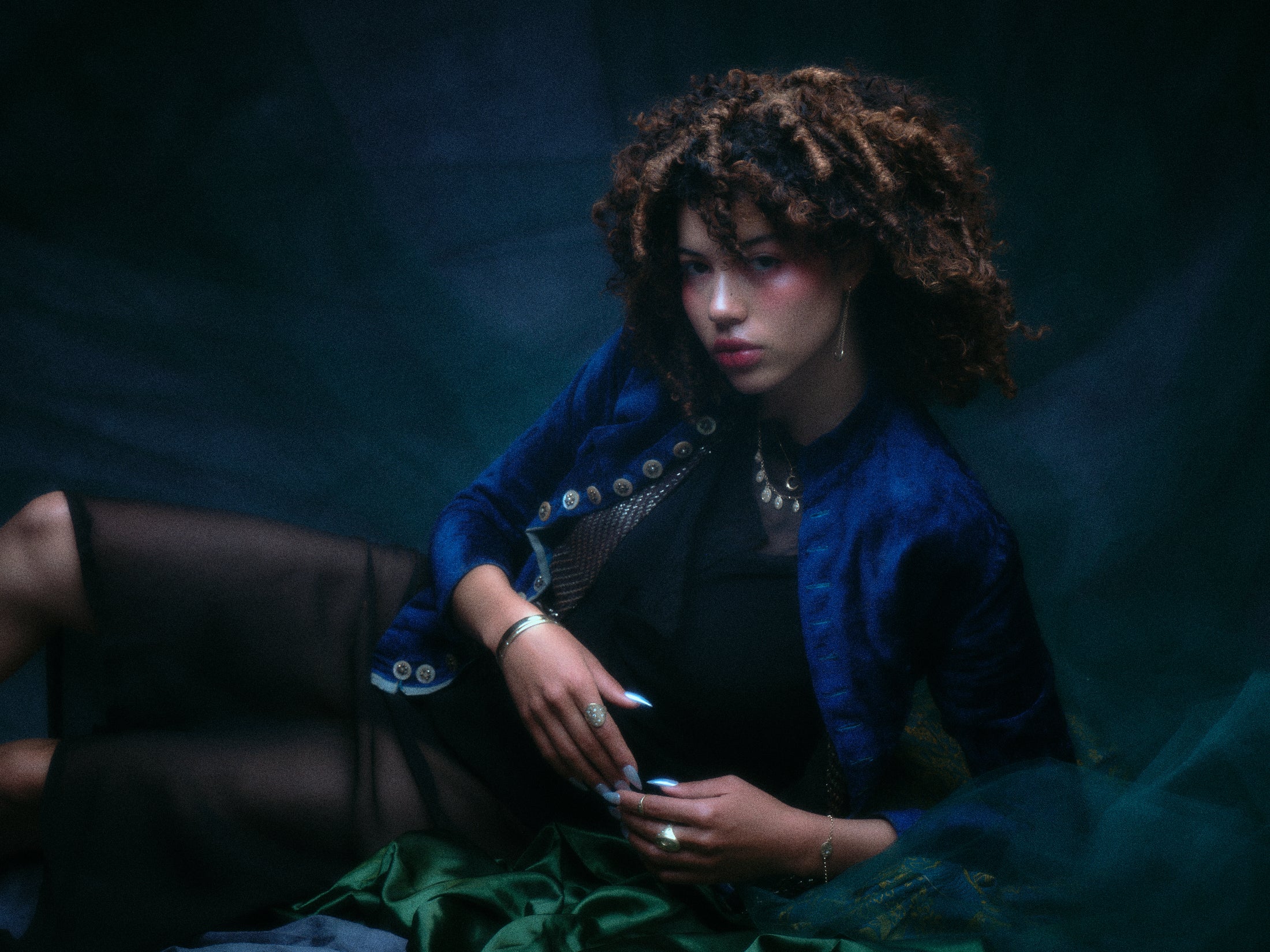 Model wearing the 14k yellow gold bangle along with other jewelry.