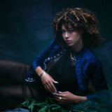Model wearing the night sky dangle necklace along with other jewelry.