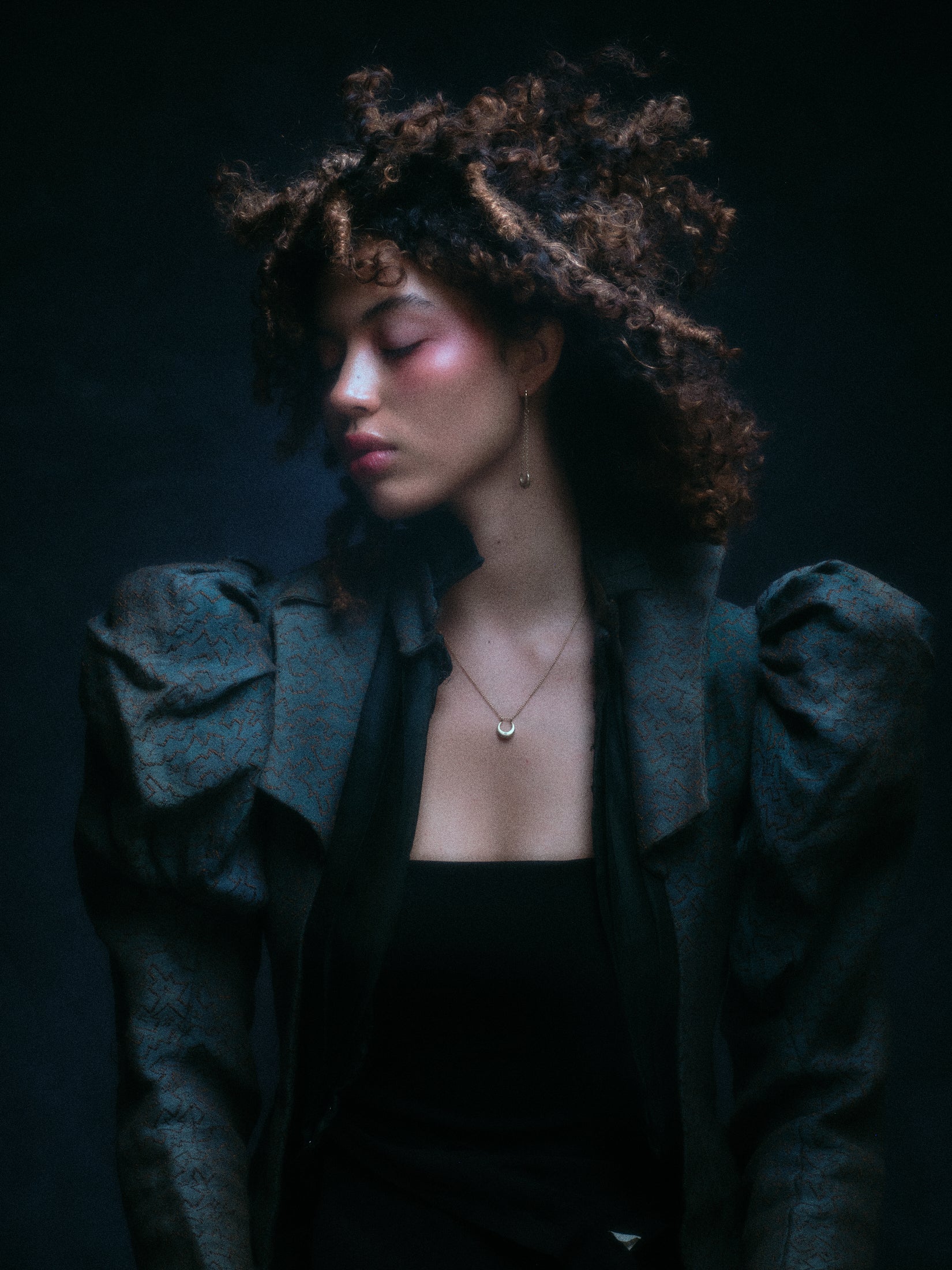 Model wearing crescent moon earring along with other jewelry.