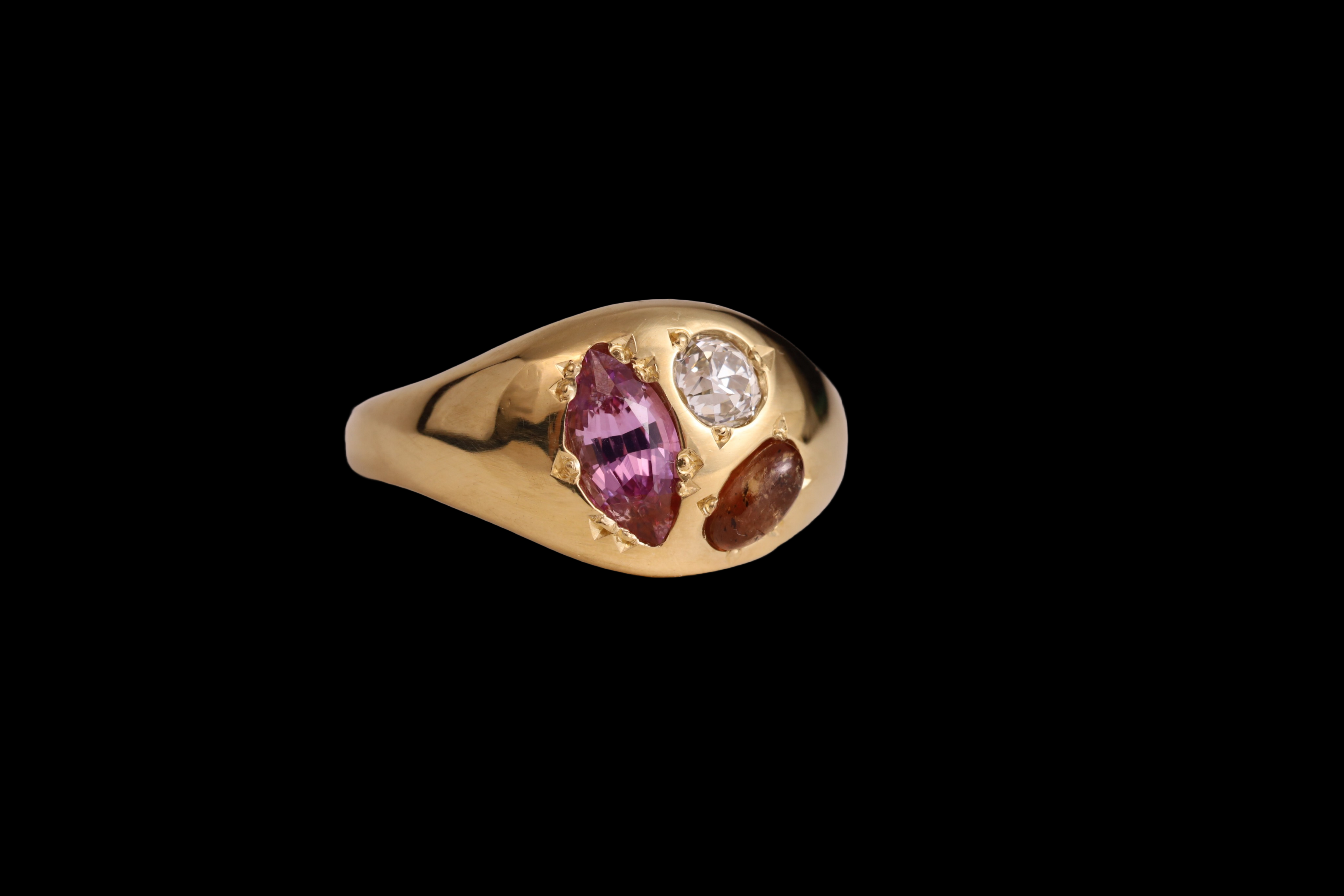 Three quarter view of 18k yellow gold gem palette ring with trio of unique gems, an old mine cut diamond, 
marquise cut particular sapphire, and Mayo Sapphire cabochon.