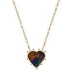 Heart shaped boulder opal pendant in 14k gold with 9 granulated gold orbs arrayed around its exterior attached to a 14k yellow gold chain.  The is striated in colors of rust and deep blue with flashes of bright blue and green towards the bottom of the heart.