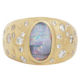 front view of opal night sky signet ring showing the central boulder opal with it's striped coloration and flashes of blue, green, and red.  Set like stars in the night sky around the central stone are white diamonds and hand engraved stars.