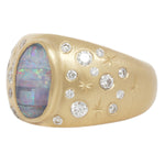 Three quarter view of opal night sky signet ring showing the central boulder opal with it's striped coloration and flashes of blue, green, and red.  Set like stars in the night sky around the central stone are white diamonds and hand engraved stars.