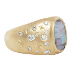 Alternate three quarter view of opal night sky signet ring showing the central boulder opal with it's striped coloration and flashes of blue, green, and red.  Set like stars in the night sky around the central stone are white diamonds and hand engraved stars.