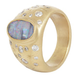 Additional three quarter view of opal night sky signet ring showing the central boulder opal with it's striped coloration and flashes of blue, green, and red.  Set like stars in the night sky around the central stone are white diamonds and hand engraved stars.