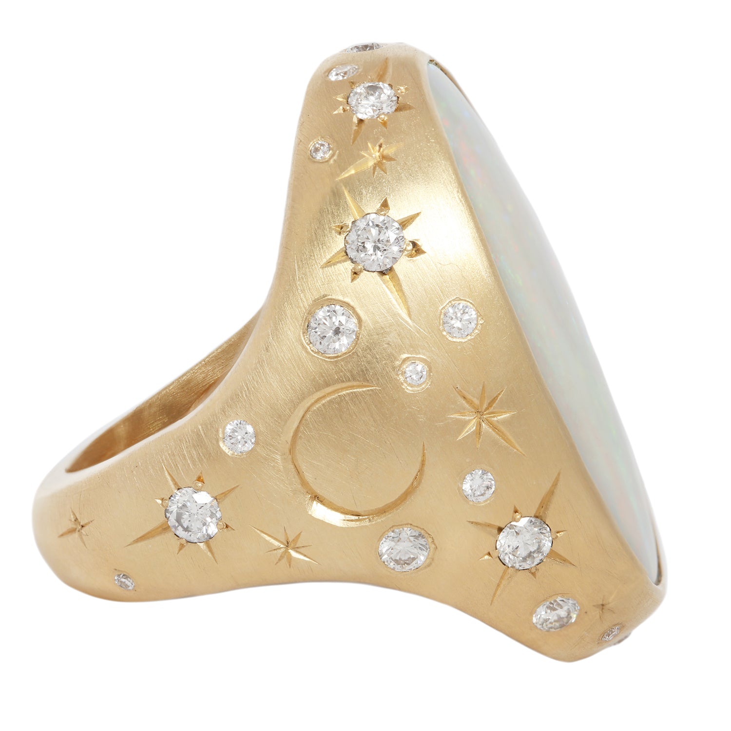 Side view of moonage daydream ring featuring a large central opal set in 18k yellow gold along with 36 white diamonds set in engraved stars along with additional star engraving and crescent moon.  