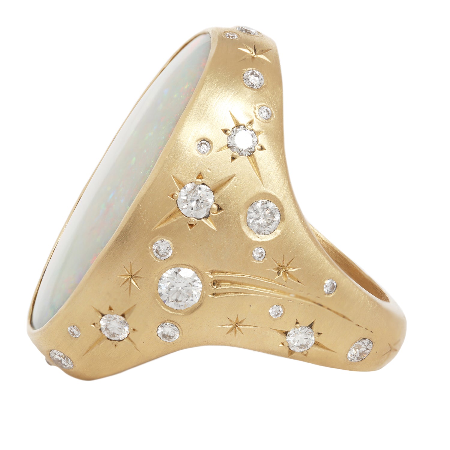 Additional sSide view of moonage daydream ring featuring a large central opal set in 18k yellow gold along with 36 white diamonds set in engraved stars along with additional star engraving and comet tail.  