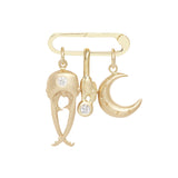 View of large 14k yellow gold charm holder with three charms dangling from it.  A beetle head, carb claw, and crescent moon.