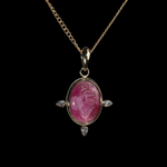 Gold pendant with an oval intaglio anatomical heart in  pink tourmaline.