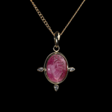 Gold pendant with an oval intaglio anatomical heart in  pink tourmaline.
