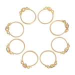 Side views of 8 yellow gold rings each with shapes inspired  by the greek hydria.