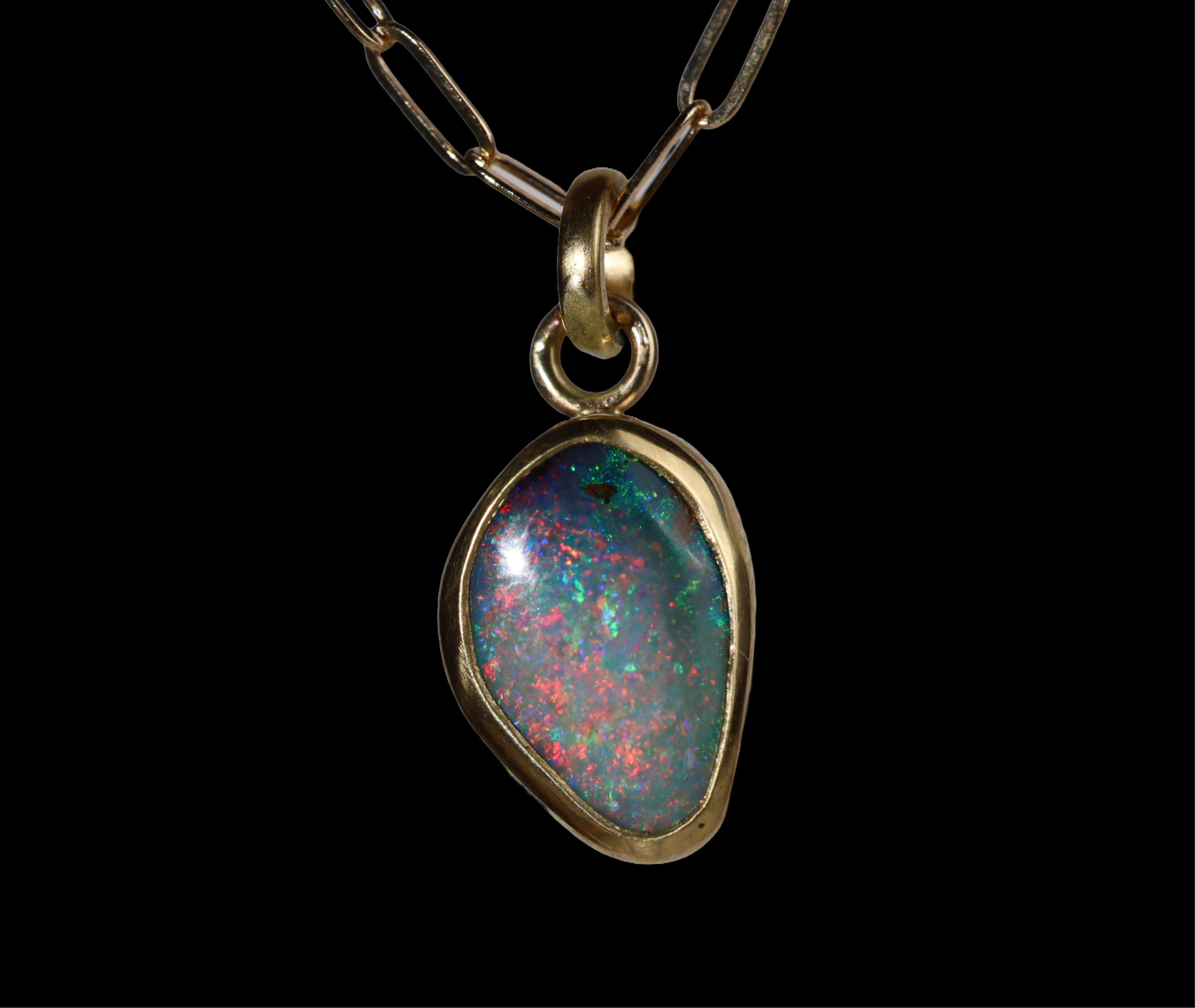 Front view of opal  pendant with green, red, and blue sparkle.