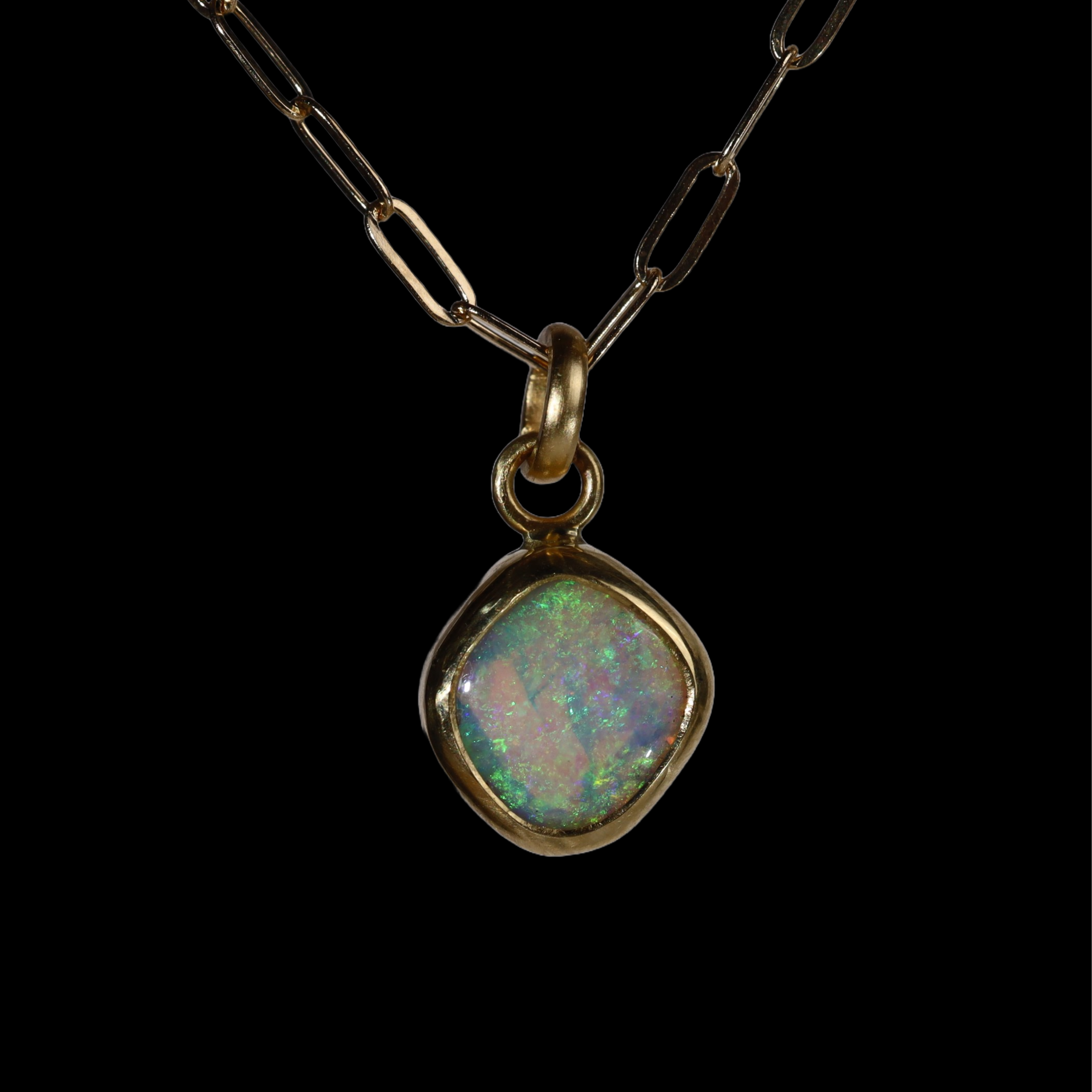 Front view of opal  pendant with green sparkle.