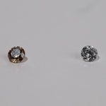 Shot of pair of diamond, champagne diamond on left and white diamond on right.