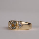 Gold ring with central particolor sapphire with a band of orange in green, flanked by diamonds.